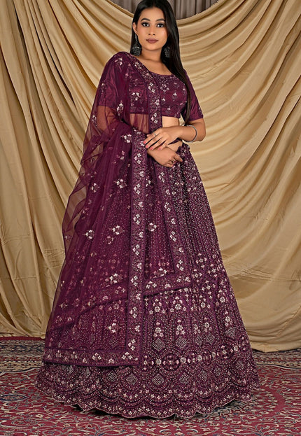 Woman wearing a purple embroidered lehenga choli with dupatta