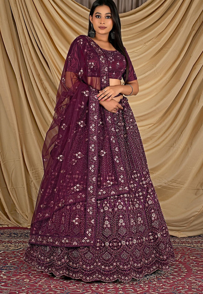 Woman wearing a purple embroidered lehenga choli with dupatta