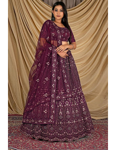 Woman wearing a purple embroidered lehenga choli with dupatta