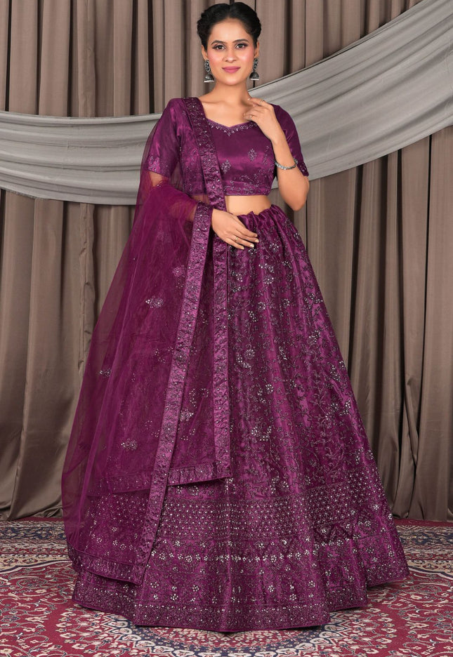Woman wearing a purple traditional outfit with a matching dupatta