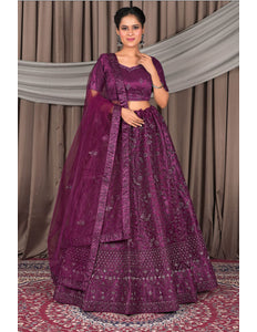 Woman wearing a purple traditional outfit with a matching dupatta