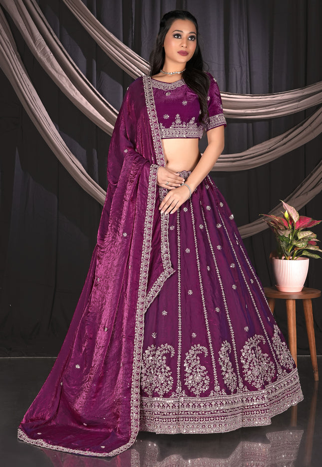 Woman wearing a purple embroidered traditional lehenga choli