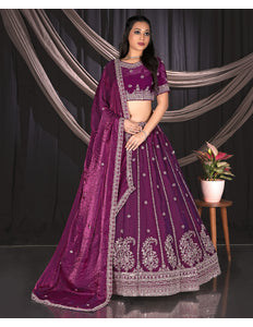 Woman wearing a purple embroidered traditional lehenga choli