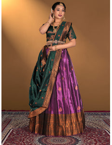 Woman wearing a traditional green and purple lehenga choli with gold border