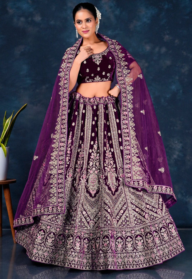 Woman wearing a traditional purple embroidered lehenga choli with dupatta