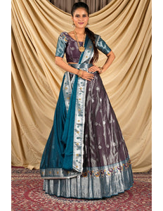 Woman wearing a traditional lehenga choli with a blue and purple