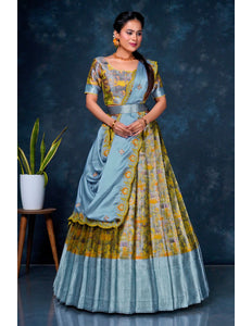 Woman wearing a traditional outfit with a blue and yellow patterned dress