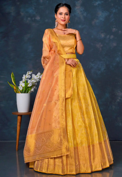 Woman in a yellow and orange lehenga choli with dupatta