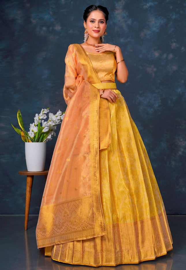 Woman in a yellow and orange lehenga choli with dupatta