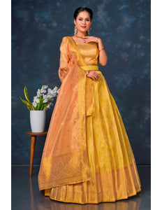 Woman in a yellow and orange lehenga choli with dupatta
