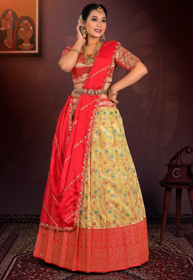 Woman wearing a red and yellow traditional outfit with intricate patterns.