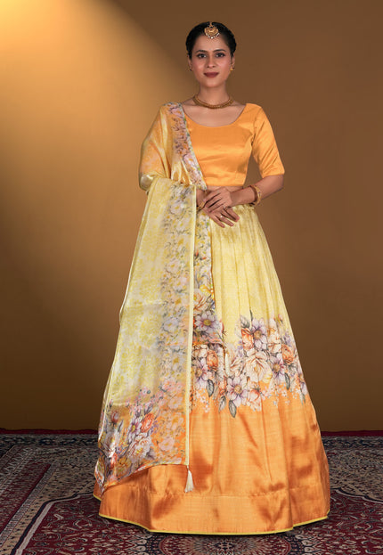 Woman wearing a traditional outfit with an gold blouse and yellow lehenga with floral patterns