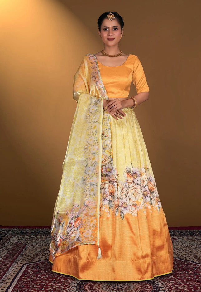 Woman wearing a traditional outfit with an gold blouse and yellow lehenga with floral patterns