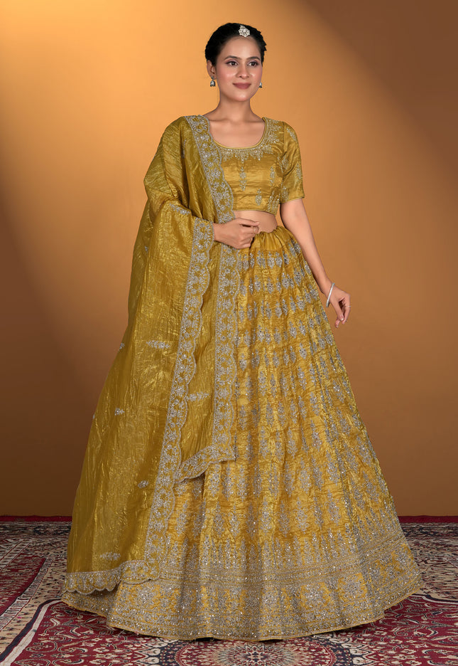 Woman wearing a traditional yellow and green outfit with intricate patterns