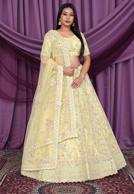 Woman wearing a light yellow embroidered lehenga choli