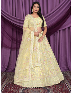 Woman wearing a light yellow embroidered lehenga choli