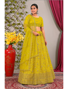 Woman in a yellow traditional lehenga choli with matching dupatta
