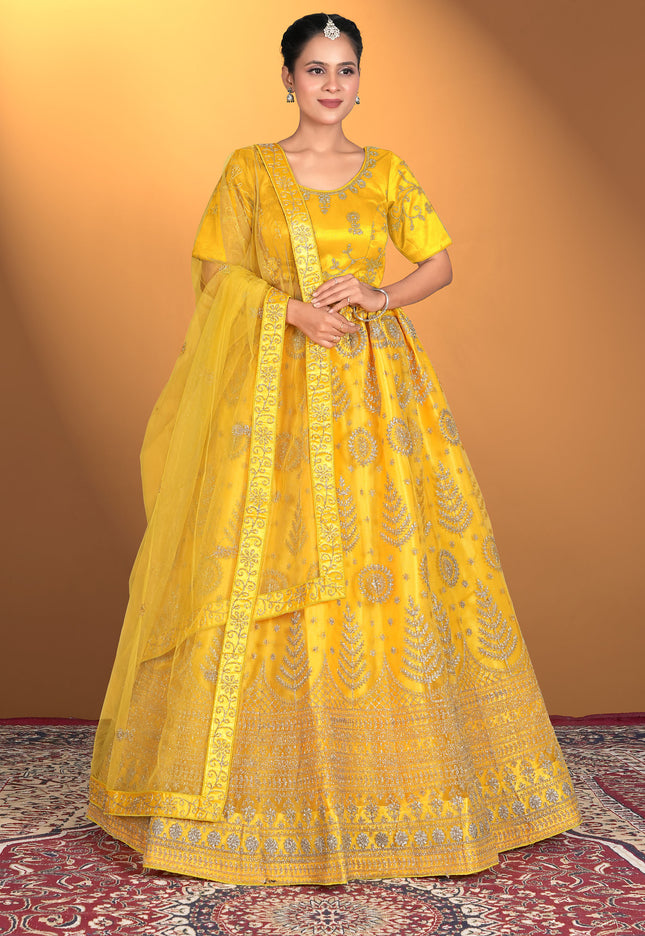Woman wearing a yellow traditional outfit with intricate patterns