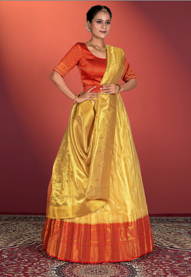 Woman wearing a traditional outfit with a yellow lehenga and red blouse