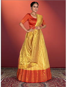 Woman wearing a traditional outfit with a yellow lehenga and red blouse