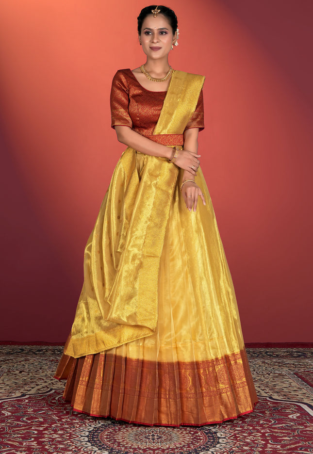 Woman wearing a traditional yellow and brown lehenga choli