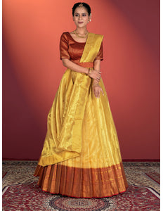 Woman wearing a traditional yellow and brown lehenga choli