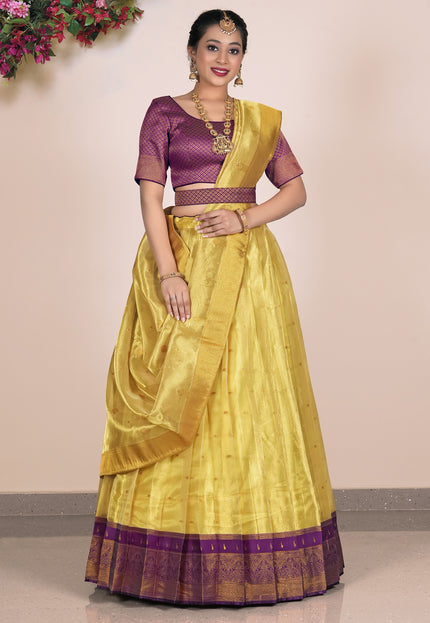 Woman wearing a yellow Lehenga with purple blouse