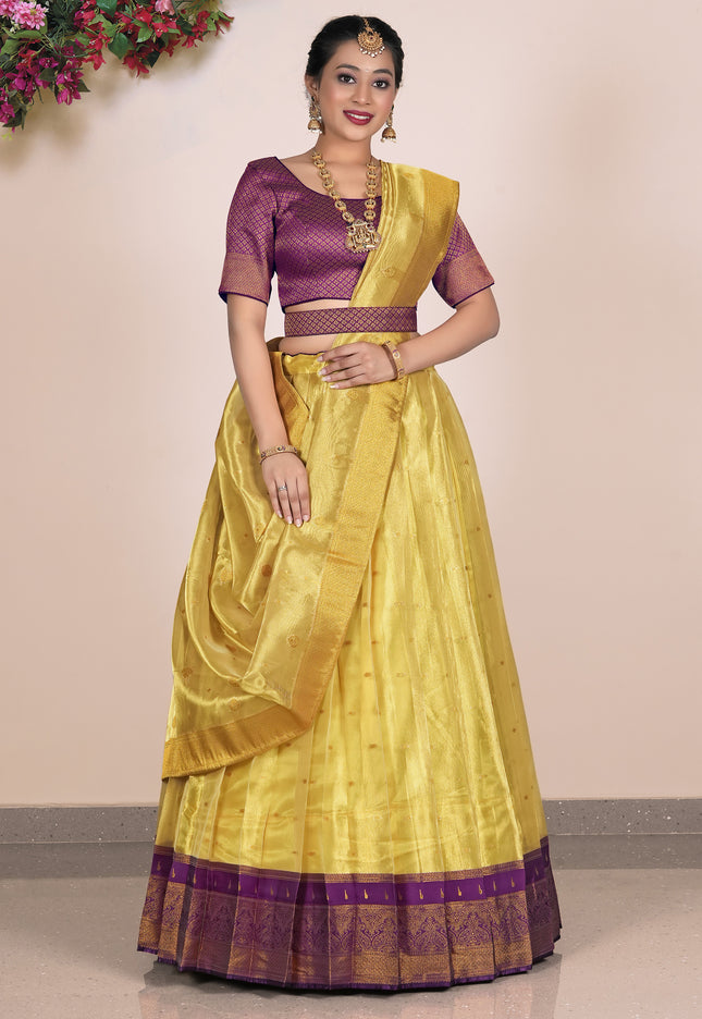 Woman wearing a yellow Lehenga with purple blouse