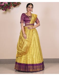 Woman wearing a yellow Lehenga with purple blouse