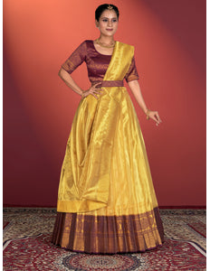 Woman wearing a yellow and maroon traditional lehenga choli
