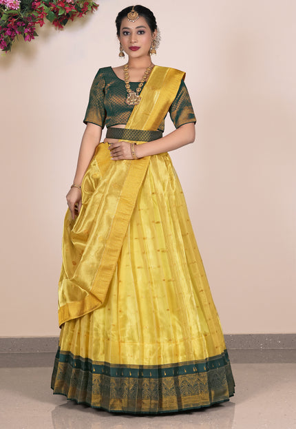 Woman wearing a yellow lehenga with green blouse