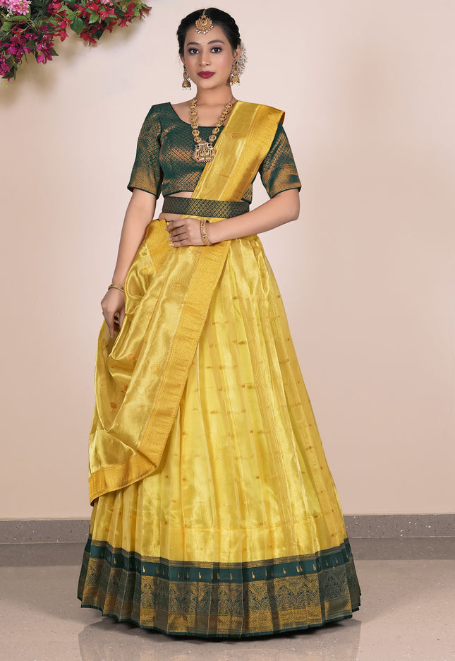 Woman wearing a yellow lehenga with green blouse