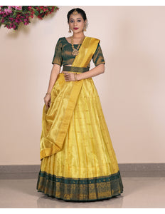 Woman wearing a yellow lehenga with green blouse