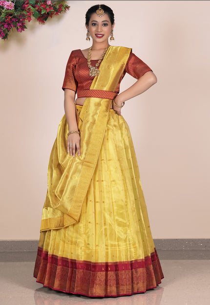 Woman wearing a yellow lehenga with red blouse