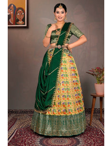 Woman wearing a traditional green and multicolored lehenga choli with dupatta