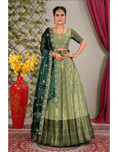 Woman in a green traditional lehenga choli with dupatta