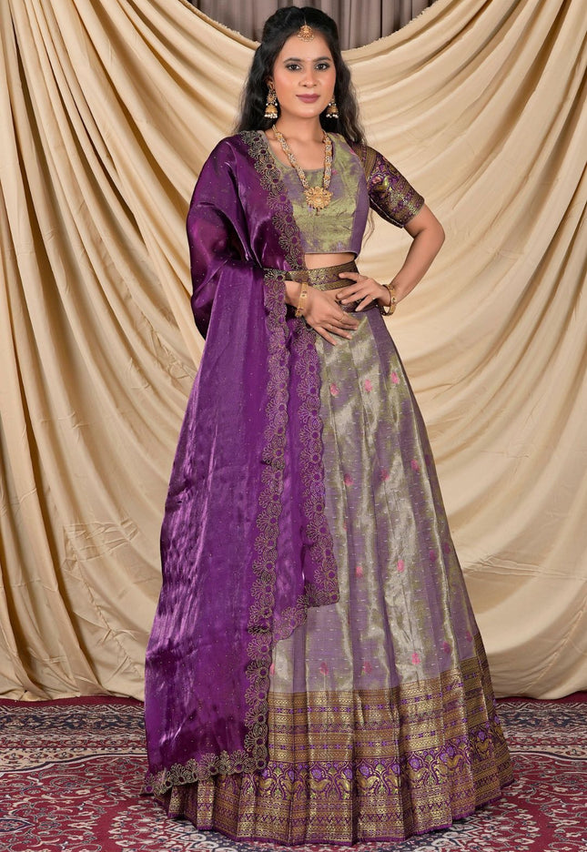 Woman wearing a traditional outfit with a purple dupatta