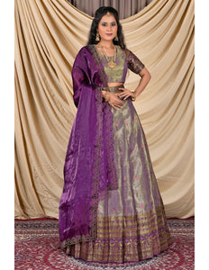Woman wearing a traditional outfit with a purple dupatta