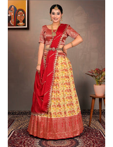 Woman in a red and yellow traditional lehenga choli with dupatta